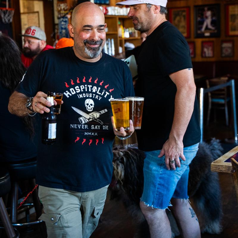 Customers carrying beers through the bar