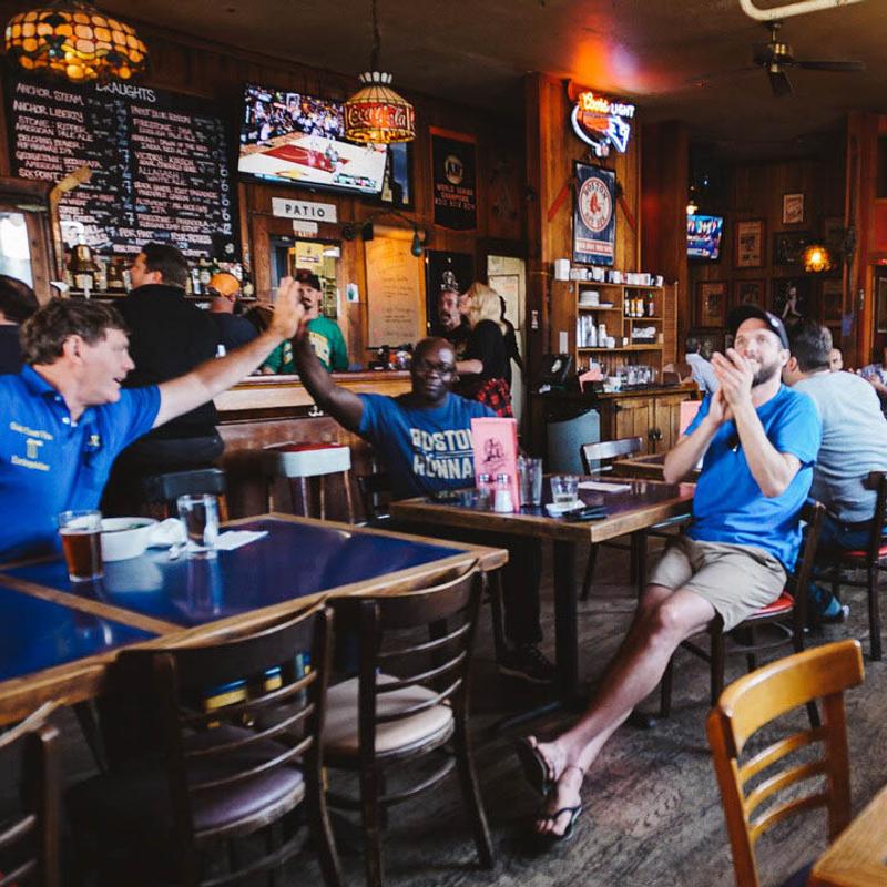 Seating area, customers cheering and watching a game