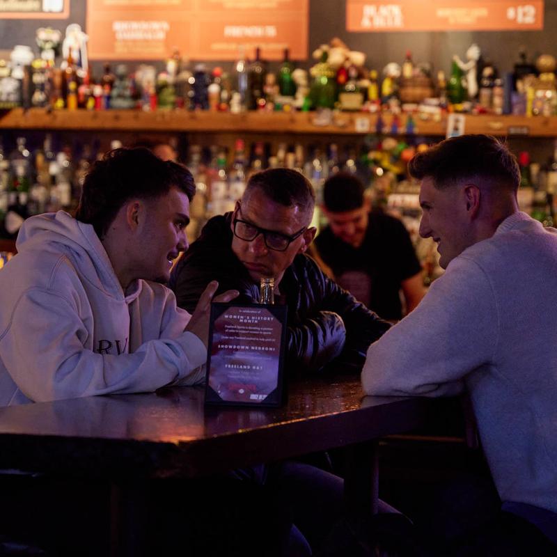 Friends talking over drinks at the bar