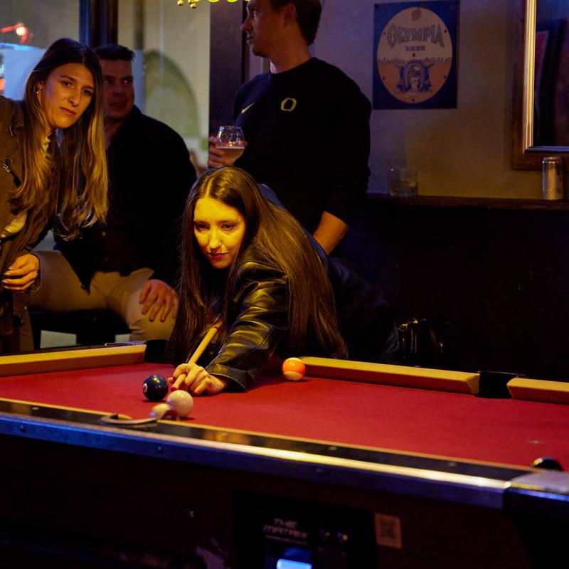 A guest lining up a shot at the pool table
