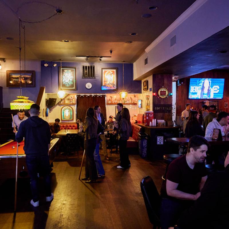 Guests playing pool in the back room