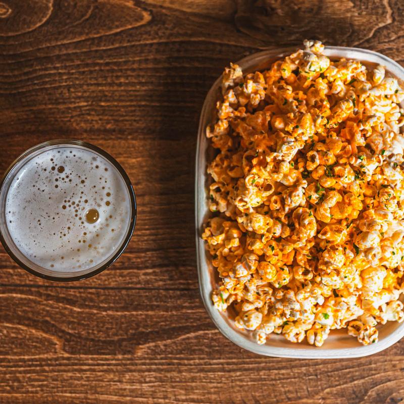 Nacho Popcorn next to a glass of beer