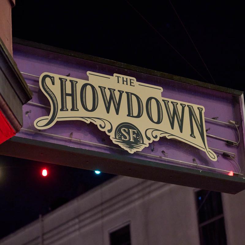 The Showdown SF sign lit up at night