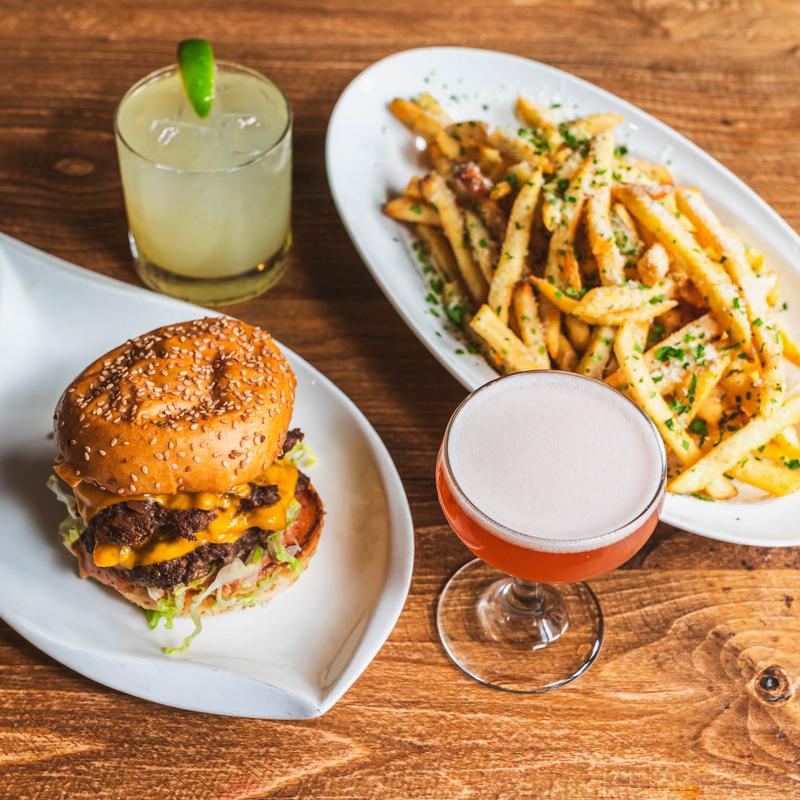 Cheeseburger served with fries and two cocktails