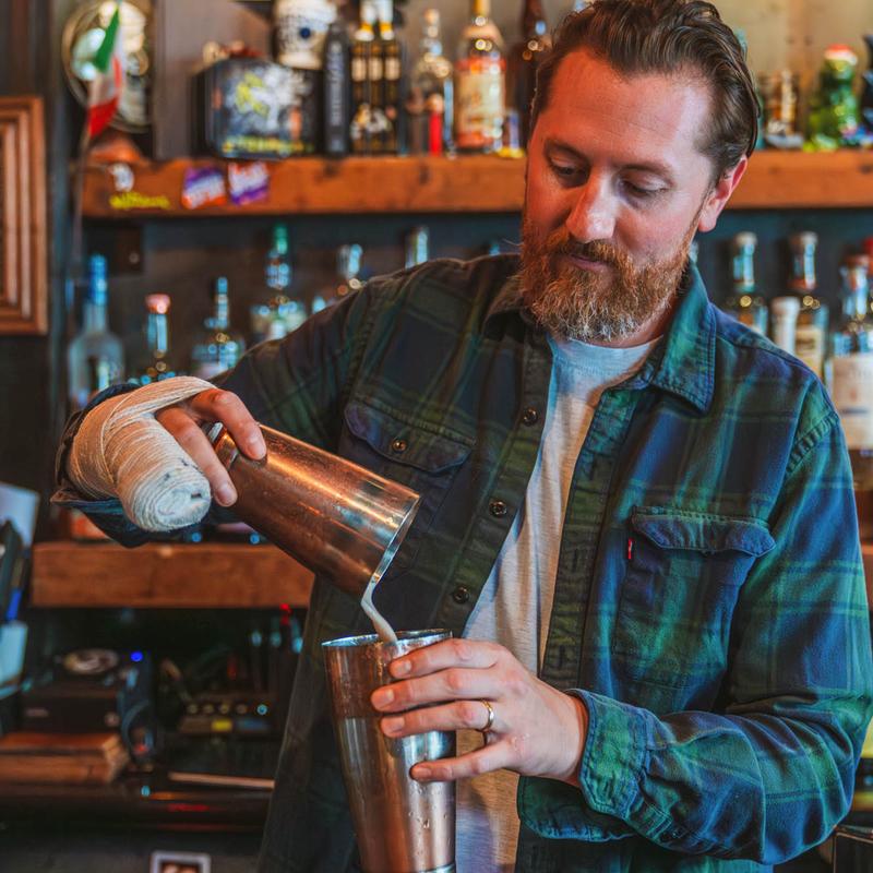 A bartender preparing a cocktail