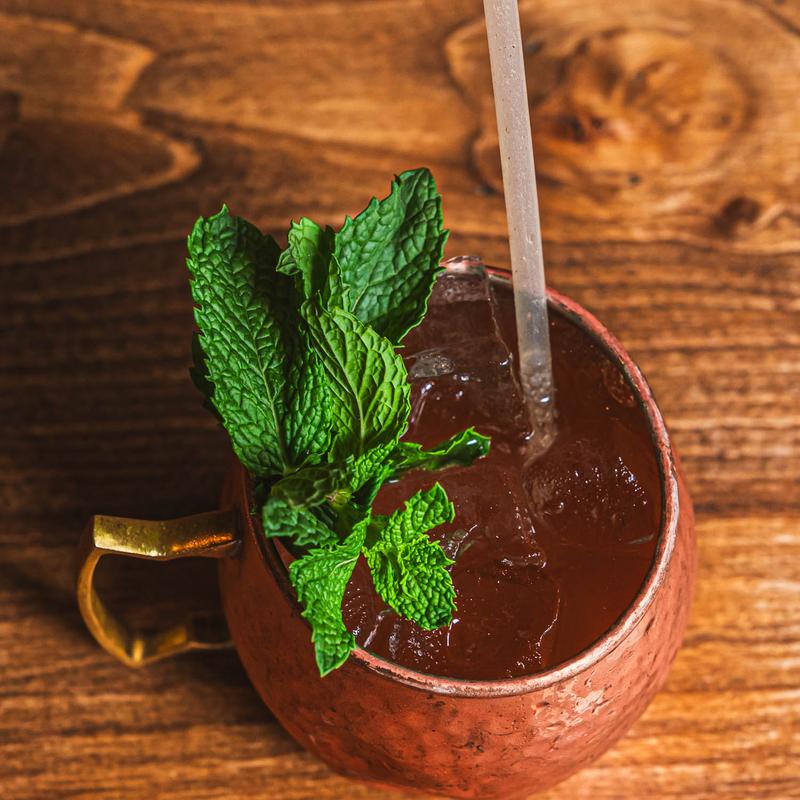 Moscow Mule cocktail in a copper mug garnished with mint
