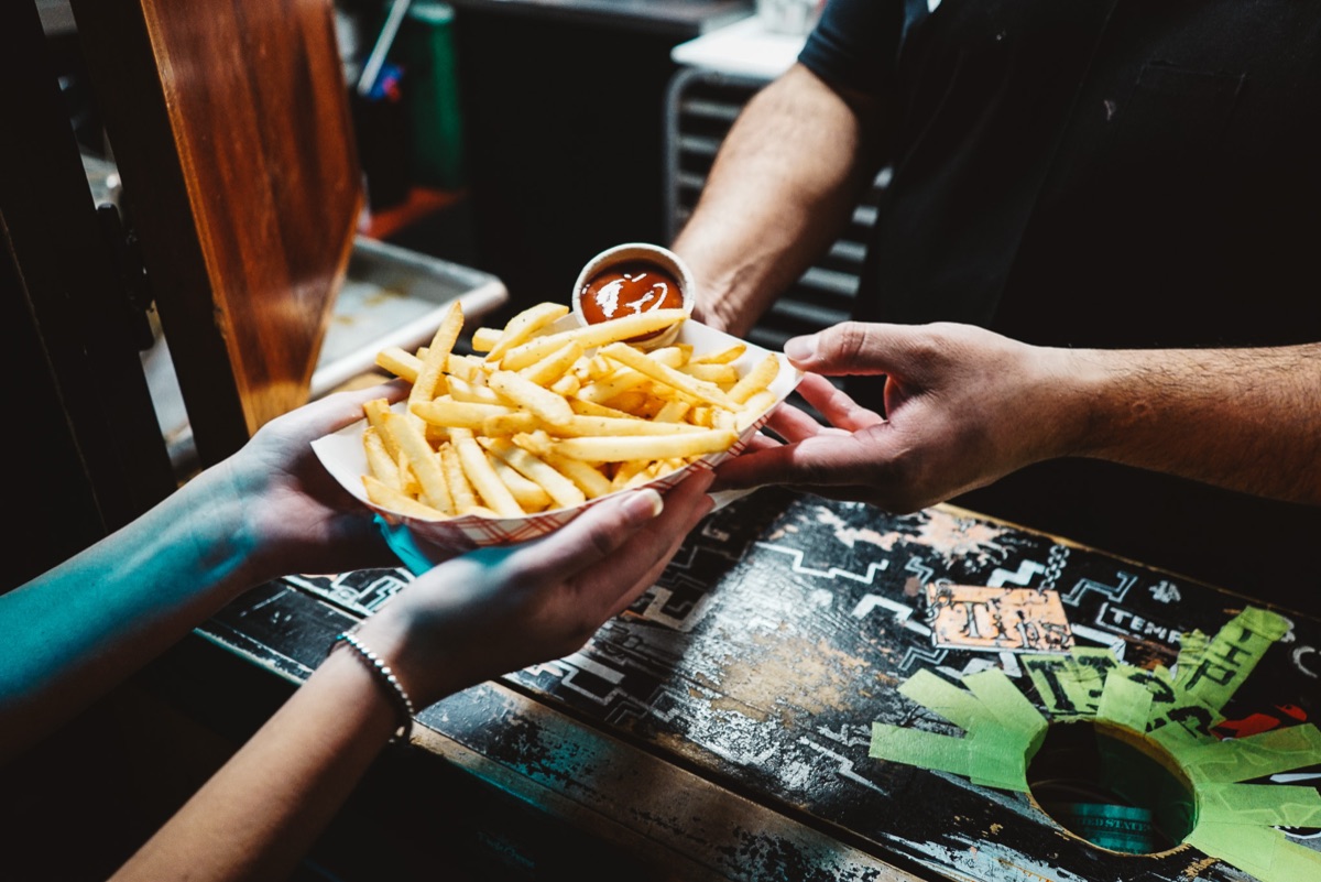 A basket of fries handed across the bar from the Box Kitchen