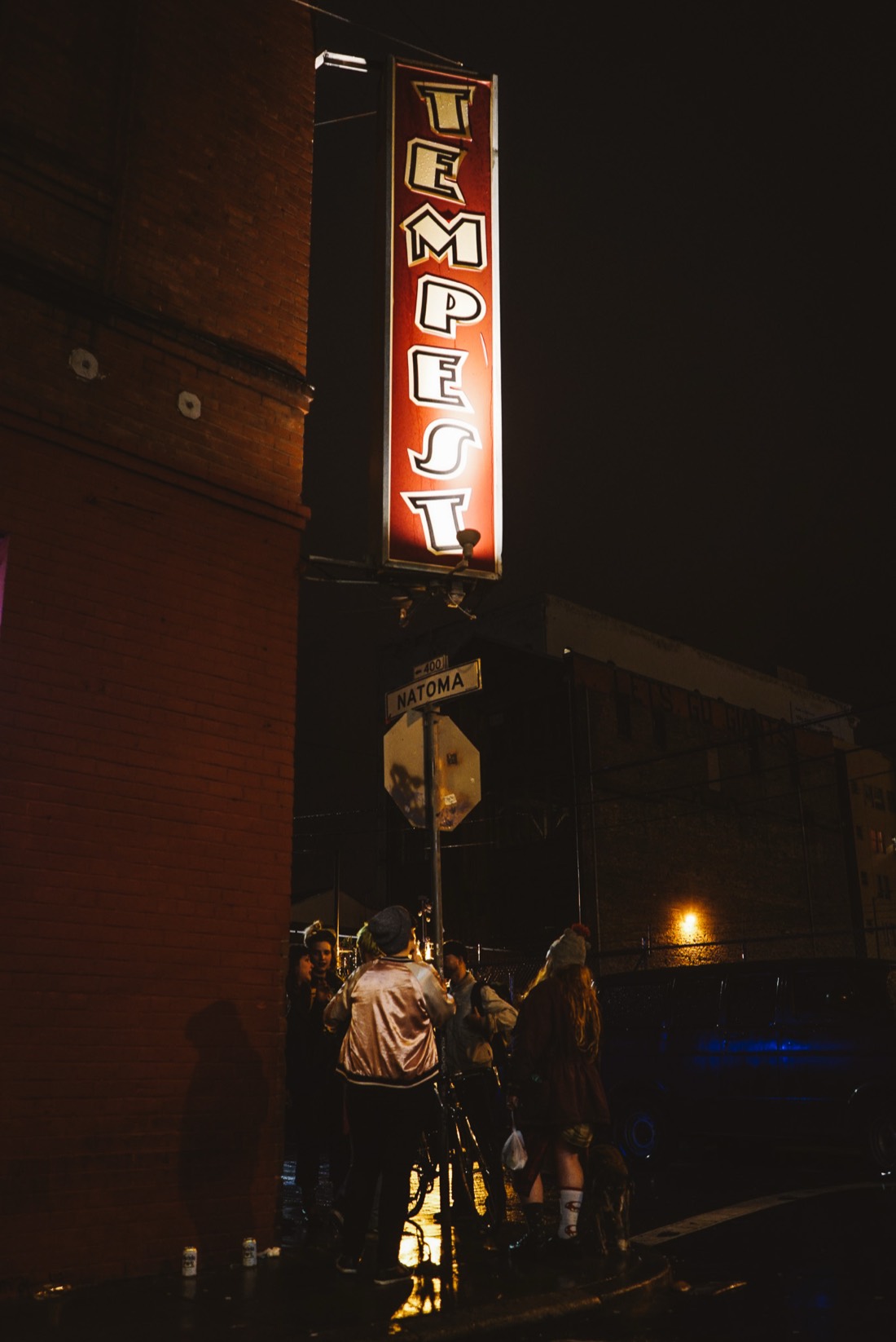 The red Tempest blade sign glowing over the Natoma Street corner at night